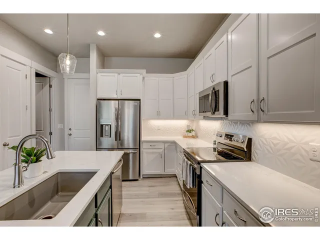 a kitchen that has a sink cabinets counter space and stainless steel appliances