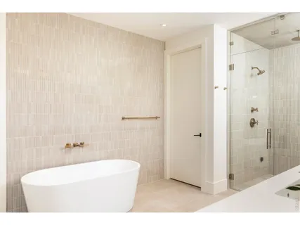 a bathroom with a bathtub and a shower