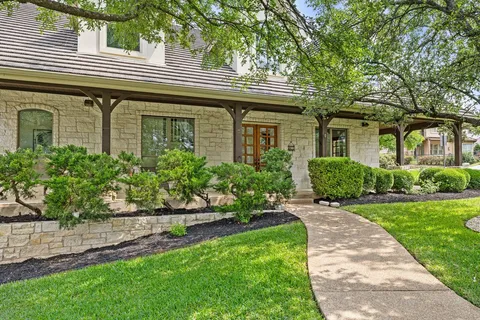 a front view of a house with a garden