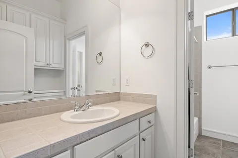a bathroom with double vanity sinks and a mirror
