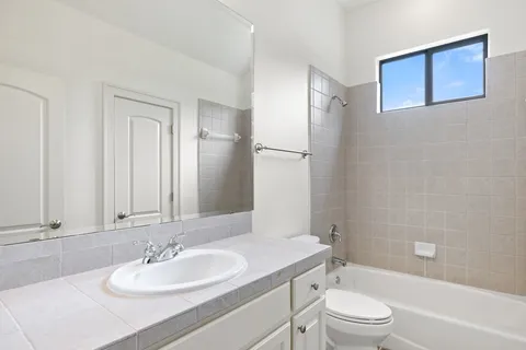 a bathroom with a toilet a sink a mirror a shower and bathtub