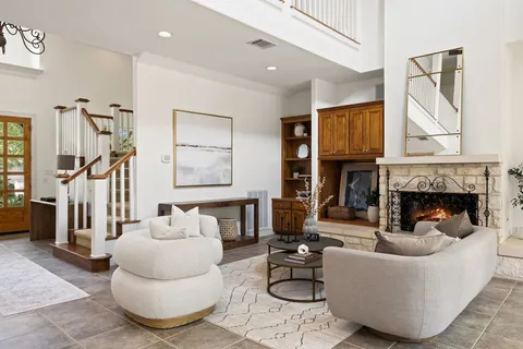 a living room with furniture and a fireplace