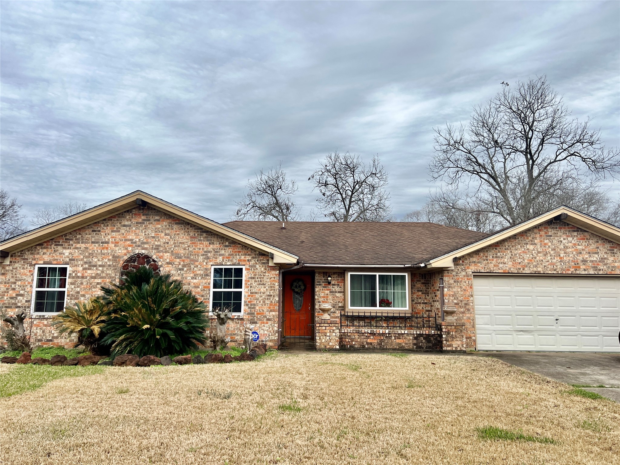 500 West 15th Street Port Arthur, TX 77640 - Photo 1 of 17 a front view of a house with a yard and garage