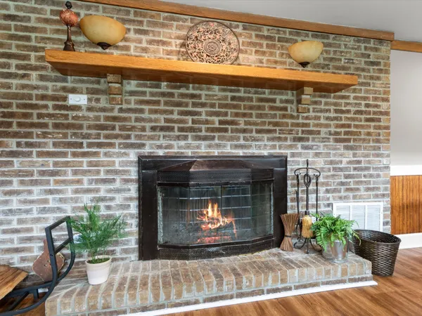 a fireplace with a vase of flowers