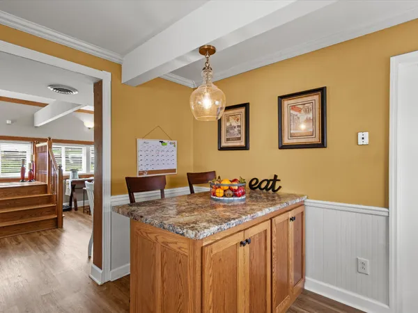 a bathroom with a granite countertop sink and a refrigerator