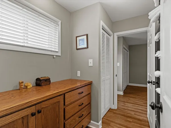 a hallway with a dresser and a window