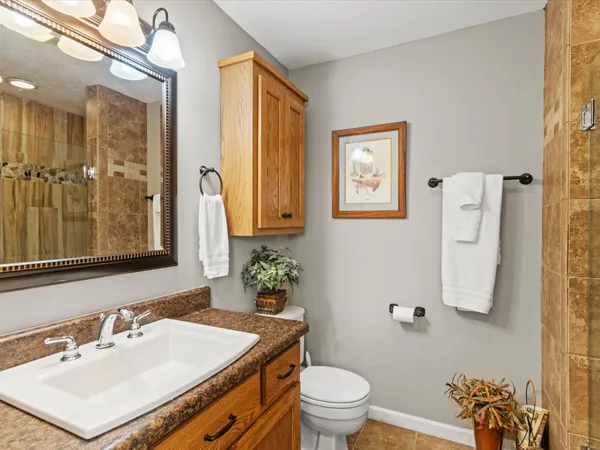 a bathroom with a sink toilet and shower