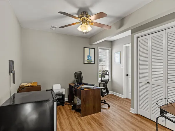 a view of a workspace with furniture and wooden floor