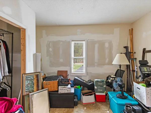 a living room with furniture a window and a flat screen tv