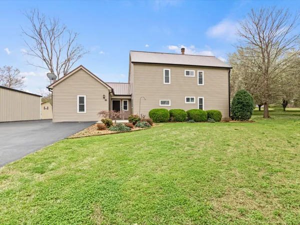 a front view of house with yard and green space