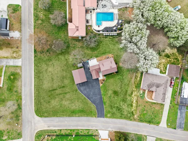 an aerial view of lake and residential houses with outdoor space