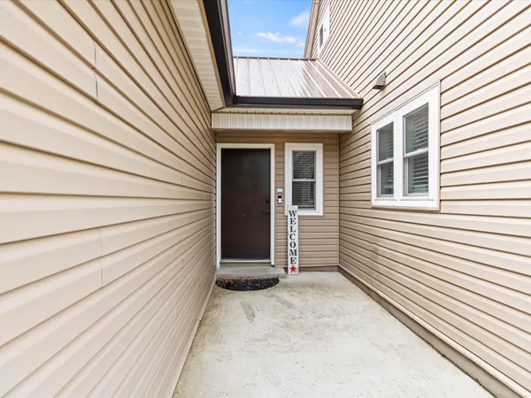 a view of a house with a door and wooden floor
