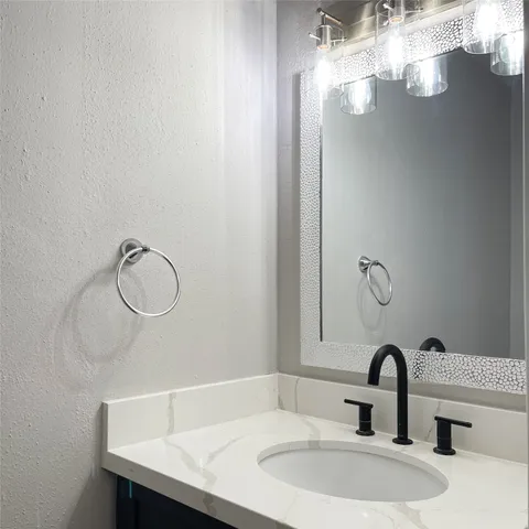 a bathroom with a sink and vanity
