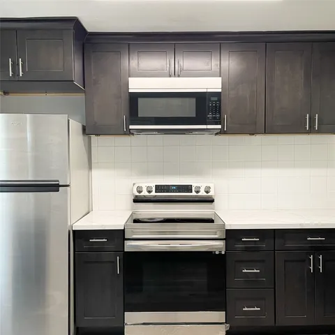 a kitchen with a stove and a microwave