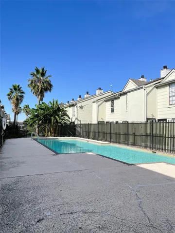 a view of a house with a backyard and road