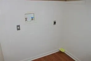 a view of storage and utility room with wooden floor