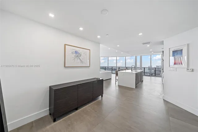 a view of kitchen with kitchen island and stainless steel appliances