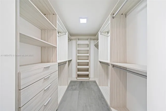 a view of walk in closet with empty racks