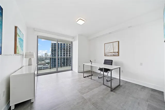a view of a livingroom with furniture and a window