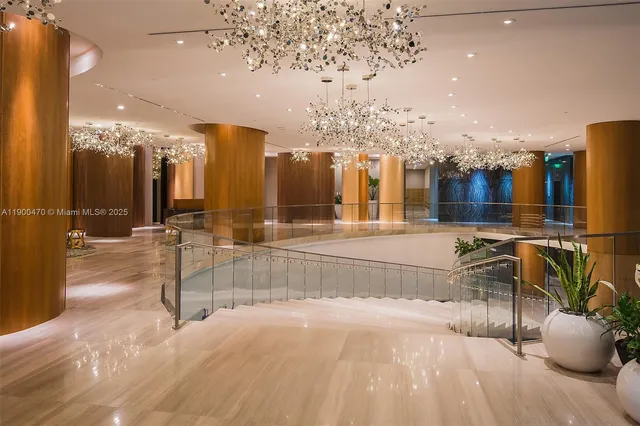 a view of a dining room with furniture a chandelier and wooden floor