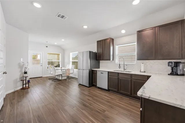 a kitchen with sink cabinets and wooden floor