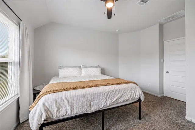 a bedroom with a bed and window