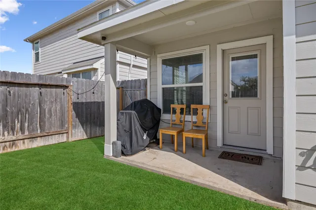 a view of a deck with chairs and backyard