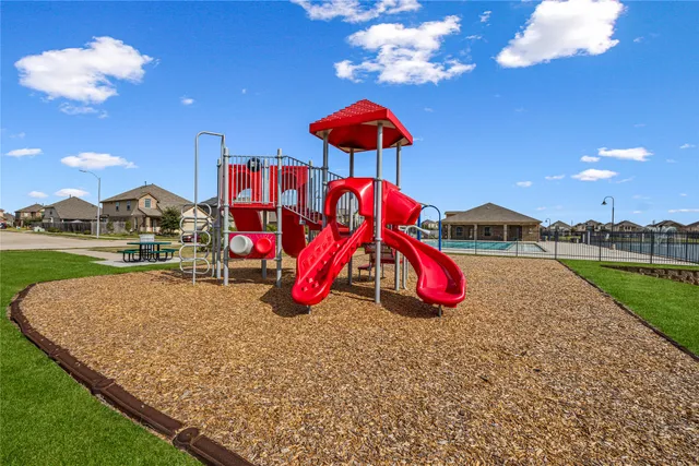 a view of outdoor space with playground and green space