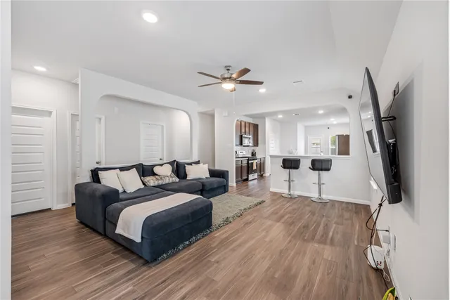 a large bedroom with a bed and a flat screen tv