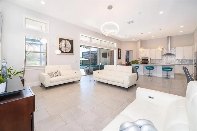 a dining room with furniture and a kitchen view