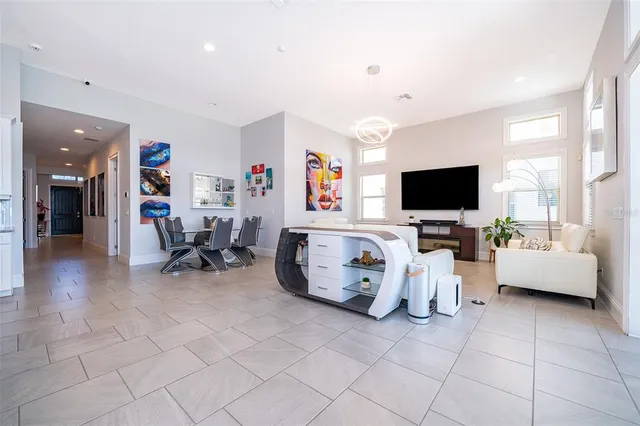 a living room with a couch and a potted plant