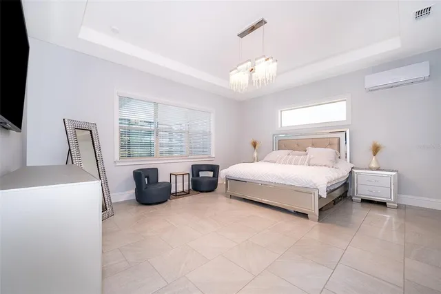 a spacious bathroom with a granite countertop sink and a mirror