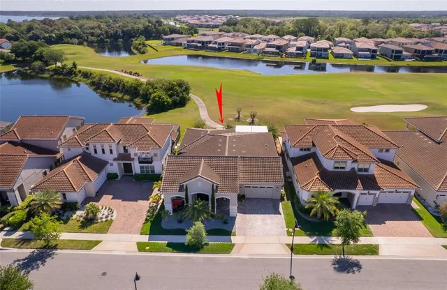 an aerial view of residential houses with outdoor space