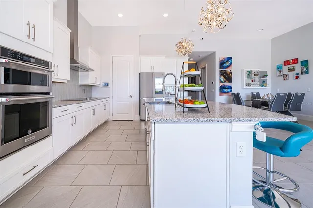 a view of a kitchen with cabinets and flat screen tv