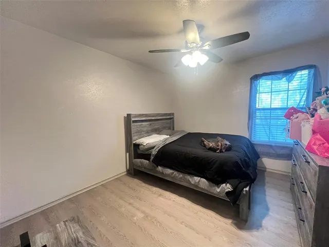 a bedroom with a bed and window