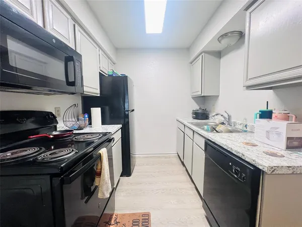 a kitchen with stainless steel appliances granite countertop a stove and a sink
