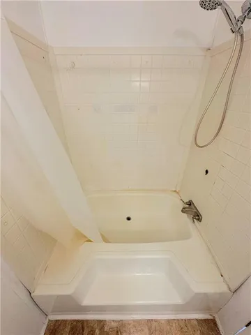 a bathroom with a granite countertop toilet and a sink