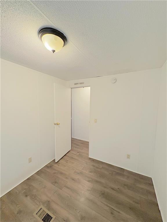 1560 Grindle Bridge Road Dahlonega, GA 30533 - Photo 16 of 21 an empty room with wooden floor and windows