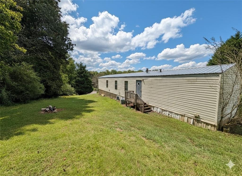 1560 Grindle Bridge Road Dahlonega, GA 30533 - Photo 2 of 21 a view of a house with backyard and garden