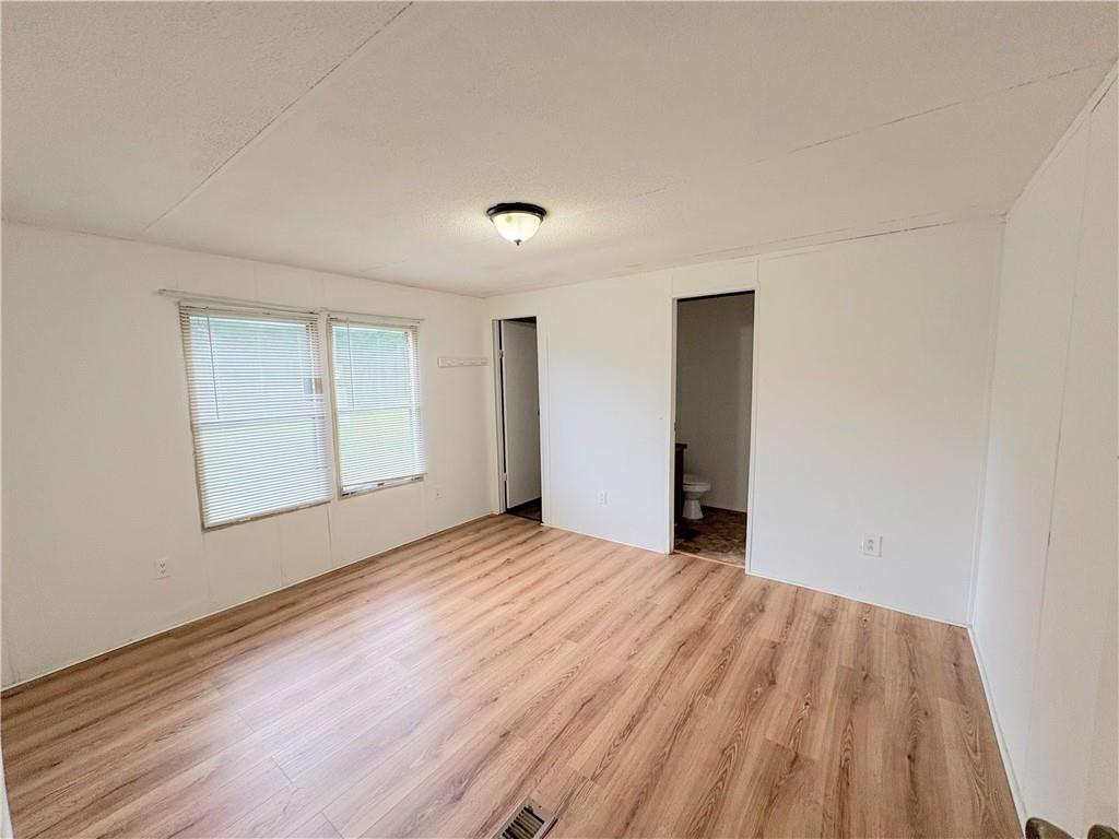1560 Grindle Bridge Road Dahlonega, GA 30533 - Photo 8 of 21 a view of an empty room with wooden floor and a window