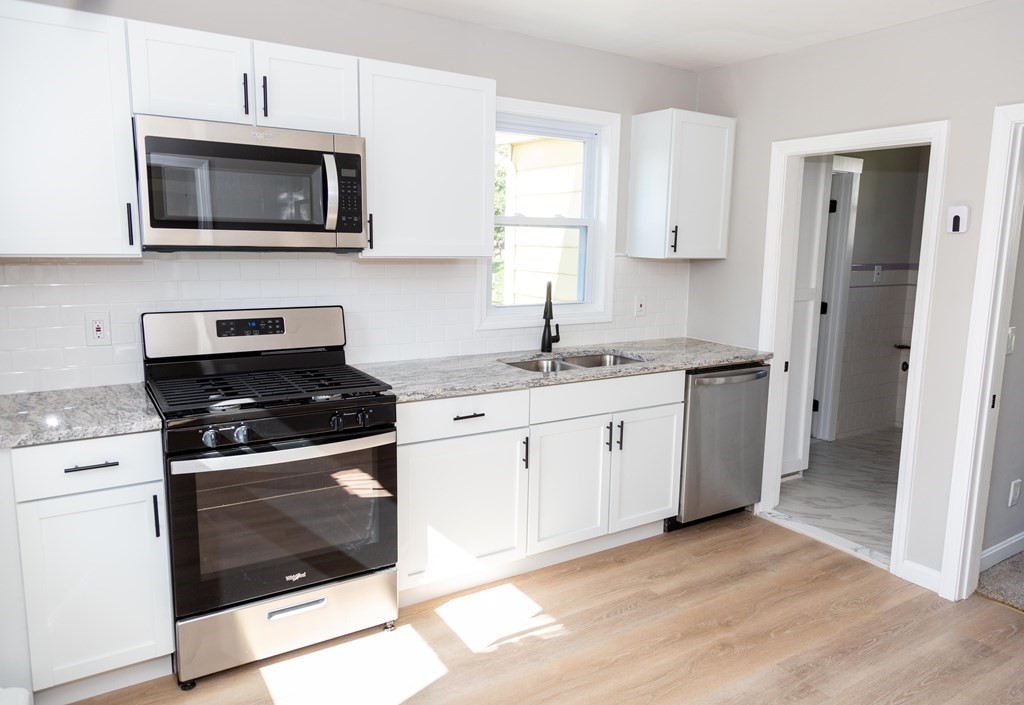 95 Wareham Road Marion, MA 02738 - Photo 2 of 14 a kitchen with stainless steel appliances granite countertop a stove a microwave and a sink
