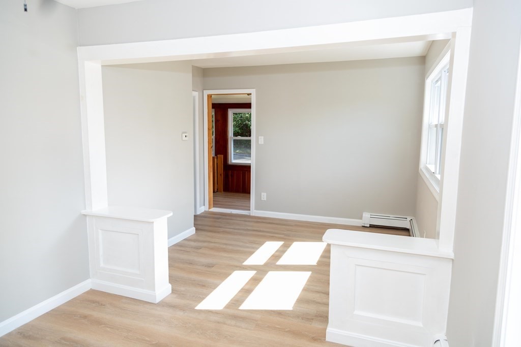 95 Wareham Road Marion, MA 02738 - Photo 8 of 14 an empty room with wooden floor and a window