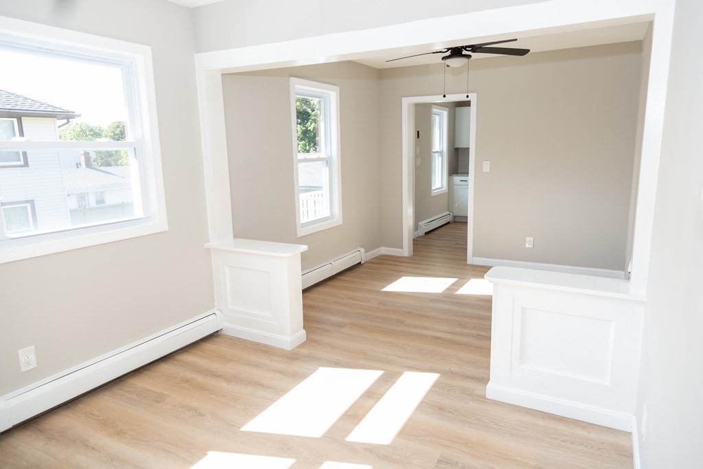 95 Wareham Road Marion, MA 02738 - Photo 9 of 14 an empty room with wooden floor and windows