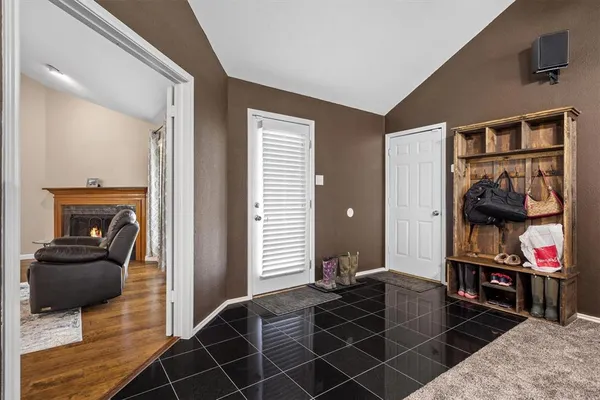 a living room with furniture a flat screen tv and a window
