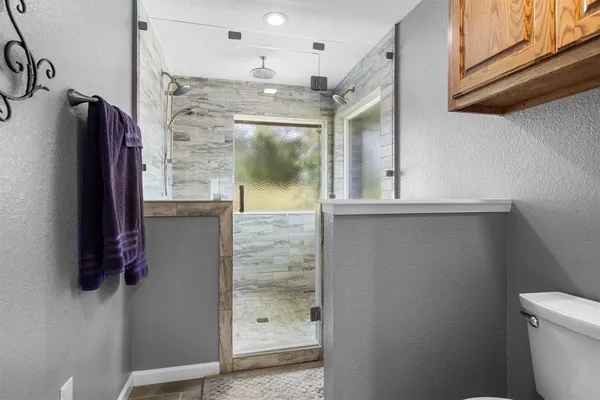 a bathroom with a shower and a sink