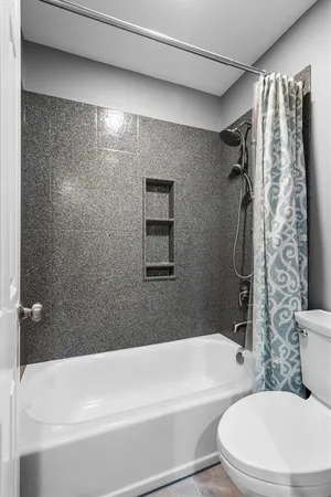 a bathroom with a toilet and a bathtub