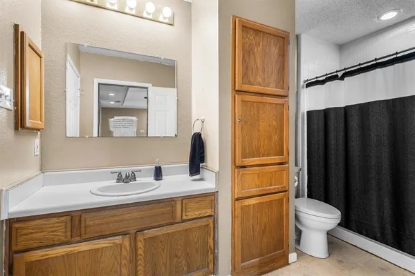 a bathroom with a sink a toilet and a mirror