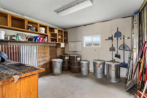 a kitchen with lots of clutter and stainless steel appliances