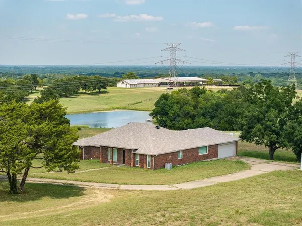 an aerial view of residential houses with outdoor space and swimming pool