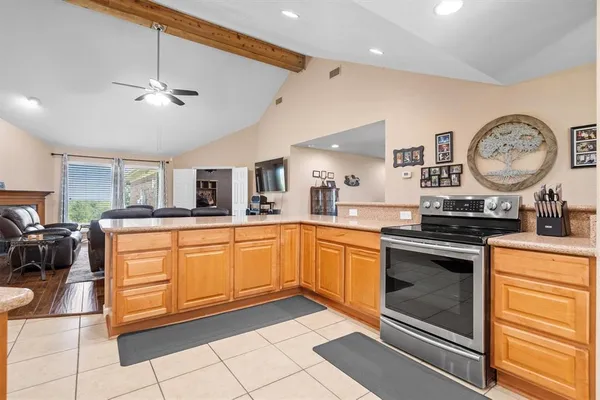 a kitchen with stainless steel appliances granite countertop a stove and white cabinets